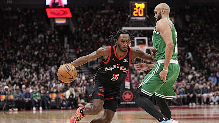 Jan 15, 2024; Toronto, Ontario, CAN; Toronto Raptors guard Immanuel Quickley (5) drives to the basket as Boston Celtics guard Derrick White (9) defends during the second half at Scotiabank Arena. Mandatory Credit: John E. Sokolowski-Imagn Images
