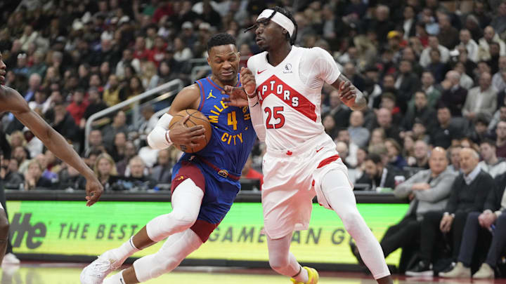 Oct 28, 2024; Toronto, Ontario, CAN; Denver Nuggets guard Russell Westbrook (4) drives to the net against Toronto Raptors forward Chris Boucher (25) during the first half at Scotiabank Arena. Mandatory Credit: John E. Sokolowski-Imagn Images