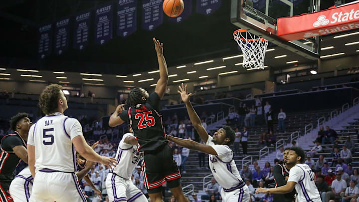 Jan 11, 2025; Manhattan, Kansas, USA; Houston Cougars guard Mercy Miller (25) shoots over Kansas State Wildcats guard Mobi Ikegwuruka (4) and center Ugonna Onyenso (34) during the second half at Bramlage Coliseum. Mandatory Credit: Scott Sewell-Imagn Images Jan 11, 2025; Manhattan, Kansas, USA; Houston Cougars guard Mercy Miller (25) shoots over Kansas State Wildcats guard Mobi Ikegwuruka (4) and center Ugonna Onyenso (34) during the second half at Bramlage Coliseum. Mandatory Credit: Scott Sewell-Imagn Images