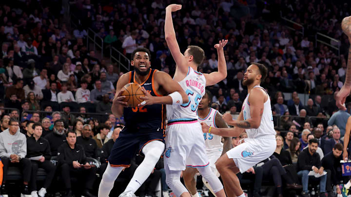New York Knicks center Karl-Anthony Towns drives to the basket against Miami Heat forwards Duncan Robinson.
