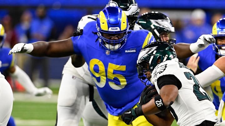 Nov 24, 2024; Inglewood, California, USA; Los Angeles Rams defensive tackle Bobby Brown III (95) tackles Philadelphia Eagles running back Saquon Barkley (26) during the first half at SoFi Stadium. Mandatory Credit: Alex Gallardo-Imagn Images Nov 24, 2024; Inglewood, California, USA; Los Angeles Rams defensive tackle Bobby Brown III (95) tackles Philadelphia Eagles running back Saquon Barkley (26) during the first half at SoFi Stadium. Mandatory Credit: Alex Gallardo-Imagn Images