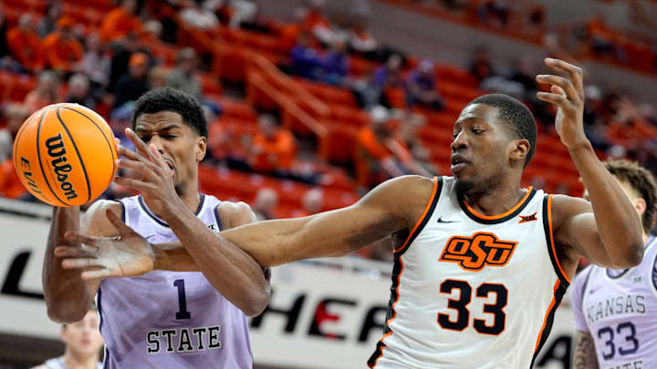 Kansas State Wildcats guard David N'Guessan (1) and Oklahoma State Cowboys forward Abou Ousmane (33) reach for the ball during a men's BIG 12 basketball game between the Oklahoma State University Cowboys (OSU) and the Kansas State Wildcats at Gallagher-Iba Arena in Stillwater, Okla., Tuesday, Jan. 7, 2025. Kansas State Wildcats guard David N'Guessan (1) and Oklahoma State Cowboys forward Abou Ousmane (33) reach for the ball during a men's BIG 12 basketball game between the Oklahoma State University Cowboys (OSU) and the Kansas State Wildcats at Gallagher-Iba Arena in Stillwater, Okla., Tuesday, Jan. 7, 2025.