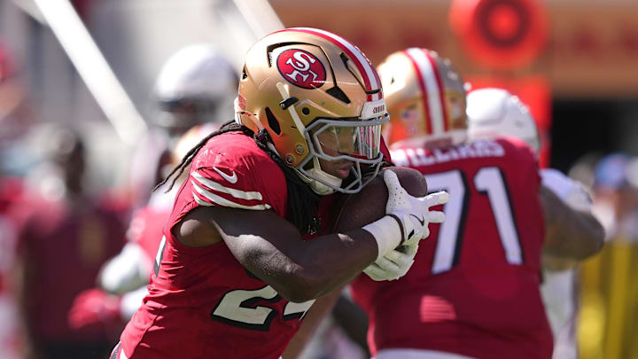Oct 6, 2024; Santa Clara, California, USA; San Francisco 49ers running back Jordan Mason (24) carries the ball against the Arizona Cardinals during the second quarter at Levi's Stadium. Mandatory Credit: Darren Yamashita-Imagn Images