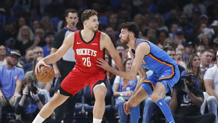 Oct 21, 2025; Oklahoma City, Oklahoma, USA; Houston Rockets center Alperen Sengun (28) drives to the basket against Oklahoma City Thunder center Chet Holmgren (7) during the first half at Paycom Center. Mandatory Credit: Alonzo Adams-Imagn Images