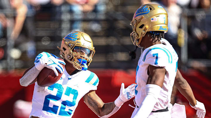 Oct 19, 2024; Piscataway, New Jersey, USA; UCLA Bruins running back Keegan Jones (22) celebrates a receiving touchdown with wide receiver J.Michael Sturdivant (7) during the second half against the Rutgers Scarlet Knights at SHI Stadium. Mandatory Credit: Vincent Carchietta-Imagn Images