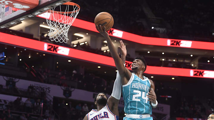 Dec 16, 2024; Charlotte, North Carolina, USA;  Charlotte Hornets forward Brandon Miller (24) drives past Philadelphia 76ers forward Paul George (8) during the second half at the Spectrum Center. Mandatory Credit: Sam Sharpe-Imagn Images