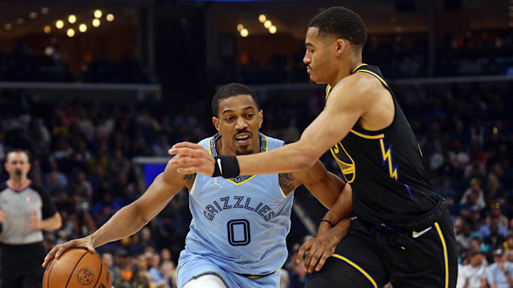 Mar 28, 2022; Memphis, Tennessee, USA; Memphis Grizzlies guard De'Anthony Melton (0) drives to the basket as Golden State Warriors guard Jordan Poole (3) defends during the first half at FedExForum. Mandatory Credit: Petre Thomas-Imagn Images