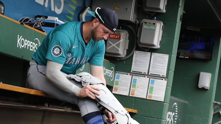 Seattle Mariners designated hitter Mitch Garver (18) puts his equipment on in the dugout before playing the Pittsburgh Pirates at PNC Park on Aug 17.