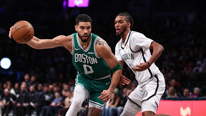 Nov 13, 2024; Brooklyn, New York, USA; Boston Celtics forward Jayson Tatum (0) loses control of the ball as Brooklyn Nets forward Ziaire Williams (1) defends during the first half at Barclays Center. Mandatory Credit: Vincent Carchietta-Imagn Images