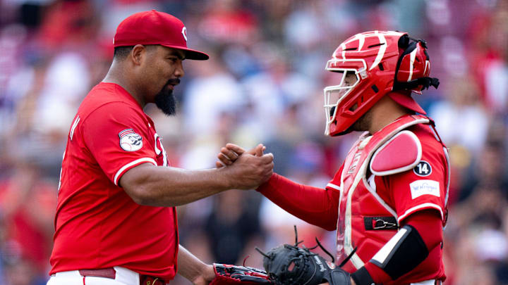 Cincinnati Reds pitcher Tony Santillan (64) and Cincinnati Reds catcher Jose Trevino (35) react after the Cincinnati Reds defeated the Chicago Cubs at Great American Ball Park in Cincinnati on Sept. 21, 2025.