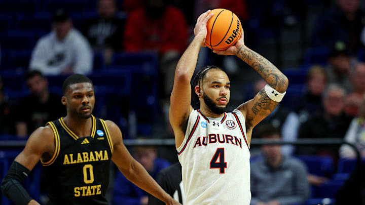 Mar 20, 2025; Lexington, KY, USA;  Auburn Tigers forward Johni Broome (4) handles the ball against Alabama State Hornets forward D'Ante Bass (0) during the second half in the first round of the NCAA Tournament at Rupp Arena. Mandatory Credit: Jordan Prather-Imagn Images