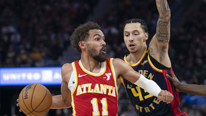 November 20, 2024; San Francisco, California, USA; Atlanta Hawks guard Trae Young (11) dribbles the basketball against Golden State Warriors forward Lindy Waters III (43) during the second quarter at Chase Center. Mandatory Credit: Kyle Terada-Imagn Images