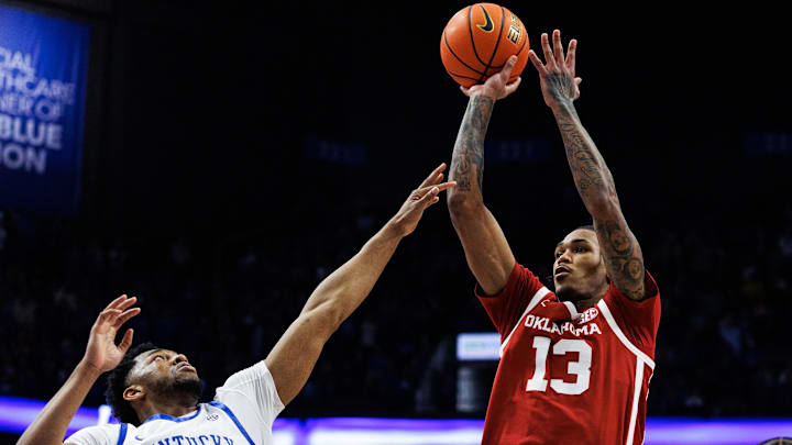 Oklahoma Sooners forward Tae Davis (13) shoots against Kentucky Wildcats forward Mouhamed Dioubate (23) during the first half at Rupp Arena at Central Bank Center.