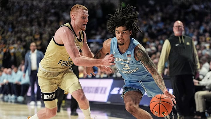 North Carolina guard Elliot Cadeau drives on Wake Forest guard Cameron Hildreth North Carolina guard Elliot Cadeau drives on Wake Forest guard Cameron Hildreth