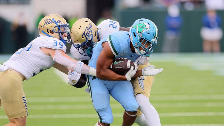 Nov 11, 2023; New Orleans, Louisiana, USA; Tulsa Golden Hurricane safety Dayne Hodge (39) and linebacker Julien Simon (24) tackle Tulane Green Wave running back Makhi Hughes (21) in the fourth quarter at Yulman Stadium. Mandatory Credit: Matthew Dobbins-USA TODAY Sports Nov 11, 2023; New Orleans, Louisiana, USA; Tulsa Golden Hurricane safety Dayne Hodge (39) and linebacker Julien Simon (24) tackle Tulane Green Wave running back Makhi Hughes (21) in the fourth quarter at Yulman Stadium. Mandatory Credit: Matthew Dobbins-USA TODAY Sports
