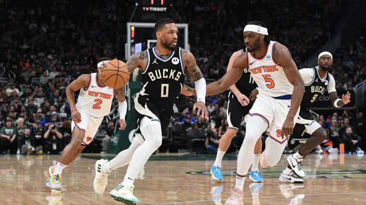 Apr 7, 2024; Milwaukee, Wisconsin, USA; Milwaukee Bucks guard Damian Lillard (0) pushes the ball up the court against New York Knicks forward Precious Achiuwa (5) i the first half at Fiserv Forum. Mandatory Credit: Michael McLoone-USA TODAY Sports