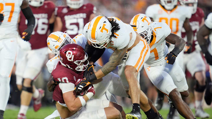 /o100/ is brought down by Tennessee Volunteers linebacker Keenan Pili (11) and defensive back Andre Turrentine (2) during a college football game between the University of Oklahoma Sooners (OU) and the Tennessee Volunteers at Gaylord Family - Oklahoma Memorial Stadium in Norman, Okla., Saturday, Sept. 21, 2024.