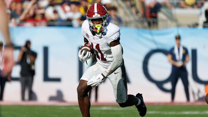 Dec 31, 2024; Tampa, FL, USA; Alabama Crimson Tide wide receiver Rico Scott (11) rushes with the ball against the Michigan Wolverines during the second half at Raymond James Stadium. Mandatory Credit: Matt Pendleton-Imagn Images