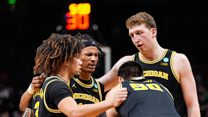 Michigan players huddle before a play against Auburn Michigan players huddle before a play against Auburn
