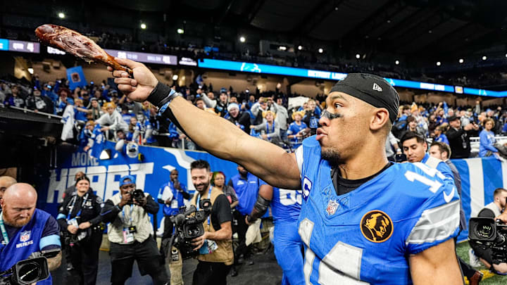 Detroit Lions wide receiver Amon-Ra St. Brown (14) waves a turkey leg at fans to celebrate 23-20 win over Chicago Bears at Ford Field in Detroit on Thursday, Nov. 28, 2024.