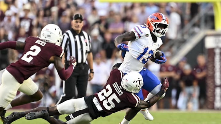 Oct 11, 2025; College Station, Texas, USA; Texas A&M Aggies safety Dalton Brooks (25) attempts to tackle Florida Gators running back Jadan Baugh (13) during the first half at Kyle Field. Mandatory Credit: Maria Lysaker-Imagn Images 