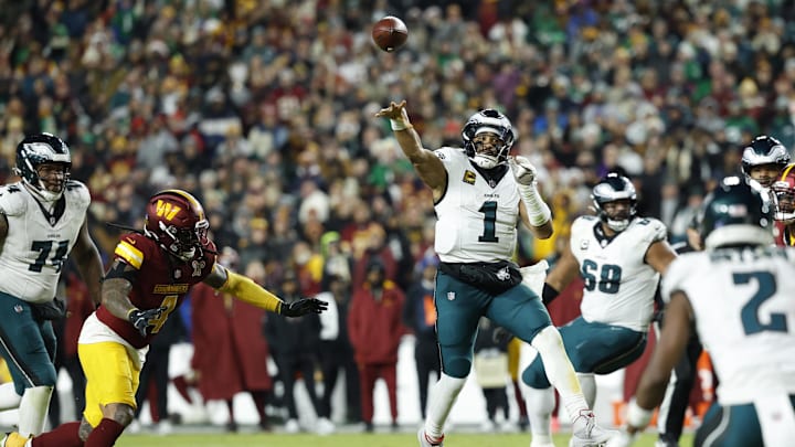 Dec 20, 2025; Landover, Maryland, USA; Philadelphia Eagles quarterback Jalen Hurts (1) passes against Washington Commanders linebacker Frankie Luvu (4) in the second half at Northwest Stadium. Mandatory Credit: Geoff Burke-Imagn Images