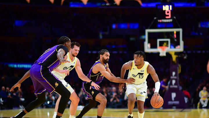Nov 19, 2024; Los Angeles, California, USA; Utah Jazz guard Isaiah Collier (13) moves the ball against Los Angeles Lakers guard Gabe Vincent (7) and center Christian Koloko (10) during the second half at Crypto.com Arena. Mandatory Credit: Gary A. Vasquez-Imagn Images