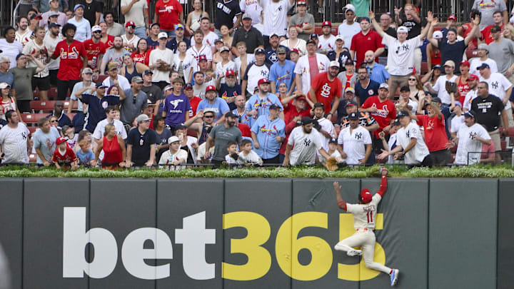 Aug 16, 2025; St. Louis, Missouri, USA;  St. Louis Cardinals center fielder Victor Scott II (11) leaps and smashes into the wall but is unable to catch a solo home run hit by New York Yankees designated hitter Aaron Judge (not pictured) during the third inning at Busch Stadium. Mandatory Credit: Jeff Curry-Imagn Images
