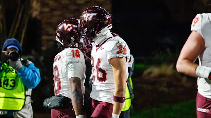 Nov 23, 2024; Durham, North Carolina, USA; Virginia Tech Hokies quarterback William Watson III (18) and wide receiver Ayden Greene (26) celebrates a touchdown during the second half of the game against Duke Blue Devils at Wallace Wade Stadium. Mandatory Credit: Jaylynn Nash-Imagn Images