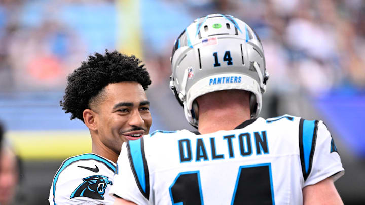 Sep 29, 2024; Charlotte, North Carolina, USA;  Carolina Panthers quarterback Andy Dalton (14) and quarterback Bryce Young (9) talk on the sidelines in the fourth quarter at Bank of America Stadium. Mandatory Credit: Bob Donnan-Imagn Images