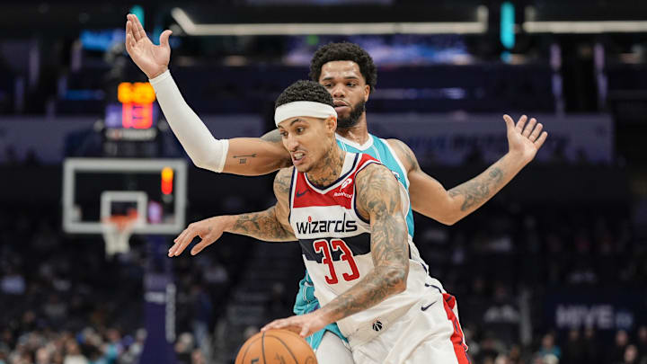 Feb 3, 2025; Charlotte, North Carolina, USA; Washington Wizards forward Kyle Kuzma (33) goes to the basket defended by Charlotte Hornets forward Miles Bridges (0) during the second half at Spectrum Center. Mandatory Credit: Jim Dedmon-Imagn Images