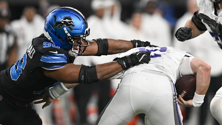 Dec 25, 2025; Minneapolis, Minnesota, USA; Detroit Lions linebacker Al-Quadin Muhammad (96) sacks Minnesota Vikings quarterback Max Brosmer (12) in the second quarter at U.S. Bank Stadium. Mandatory Credit: Jeffrey Becker-Imagn Images