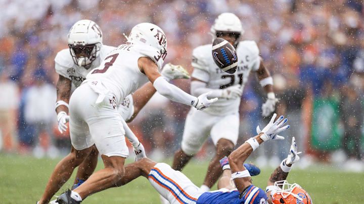 Sep 14, 2024; Gainesville, Florida, USA; Florida Gators wide receiver Marcus Burke (88) and Texas A&M Aggies defensive back Marcus Ratcliffe (3) battle for the ball during the first half at Ben Hill Griffin Stadium. Mandatory Credit: Matt Pendleton-Imagn Images
