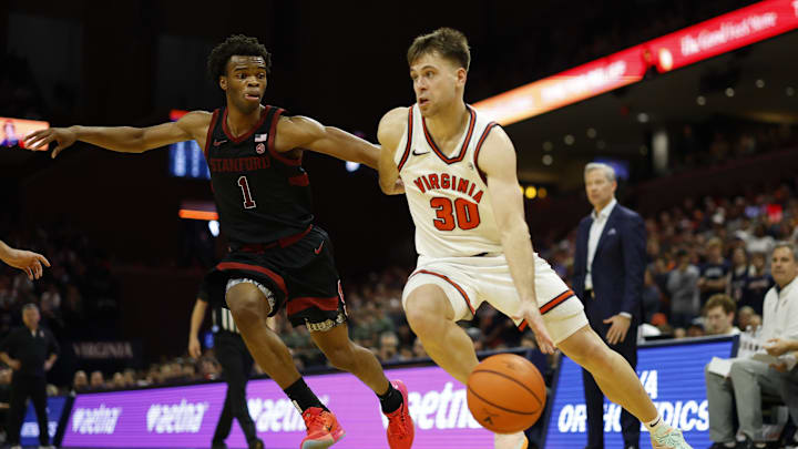 Jan 10, 2026; Charlottesville, Virginia, USA; Virginia Cavaliers guard Dallin Hall (30) drives to the basket as Stanford Cardinal guard Ebuka Okorie (1) defends in the second half at John Paul Jones Arena. Mandatory Credit: Geoff Burke-Imagn Images