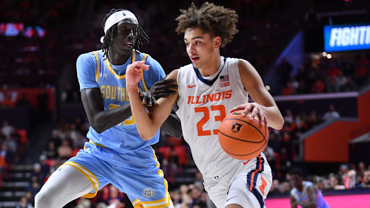 Dec 29, 2025; Champaign, Illinois, USA;  Illinois Fighting Illini guard Keaton Wagler (23) drives the ball past Southern University Jaguars guard Puoch Dobuol (35) during the first half at State Farm Center. Mandatory Credit: Ron Johnson-Imagn Images