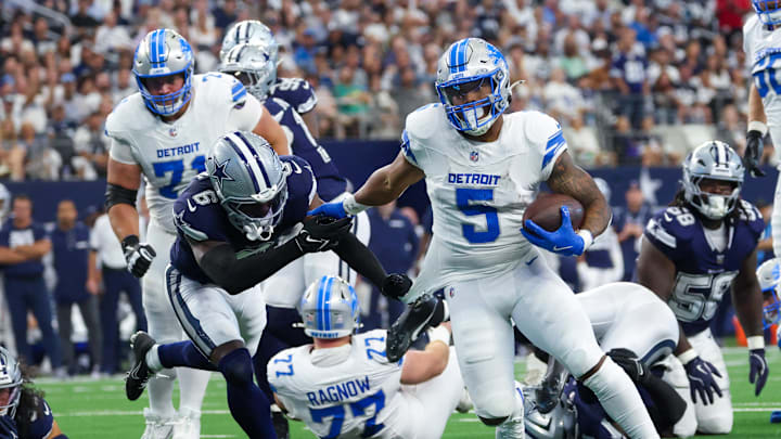 Oct 13, 2024; Arlington, Texas, USA;  Detroit Lions running back David Montgomery (5) runs for a touchdown as Dallas Cowboys safety Donovan Wilson (6) defends during the first quarter at AT&T Stadium. Mandatory Credit: Kevin Jairaj-Imagn Images