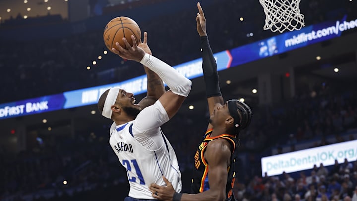 Nov 17, 2024; Oklahoma City, Oklahoma, USA; Dallas Mavericks center Daniel Gafford (21) shoots as Oklahoma City Thunder guard Shai Gilgeous-Alexander (2) defends during the second quarter at Paycom Center. Mandatory Credit: Alonzo Adams-Imagn Images