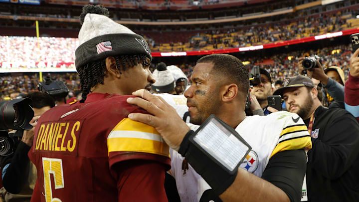 Nov 10, 2024; Landover, Maryland, USA; Washington Commanders quarterback Jayden Daniels (5) hugs Pittsburgh Steelers quarterback Russell Wilson (3) after their game at Northwest Stadium. Mandatory Credit: Geoff Burke-Imagn Images