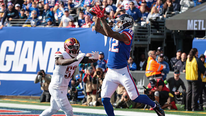 Oct 22, 2023; East Rutherford, New Jersey, USA; New York Giants tight end Darren Waller (12) catches a touchdown pass during the first half in front of Washington Commanders linebacker Jamin Davis (52) at MetLife Stadium. Oct 22, 2023; East Rutherford, New Jersey, USA; New York Giants tight end Darren Waller (12) catches a touchdown pass during the first half in front of Washington Commanders linebacker Jamin Davis (52) at MetLife Stadium.