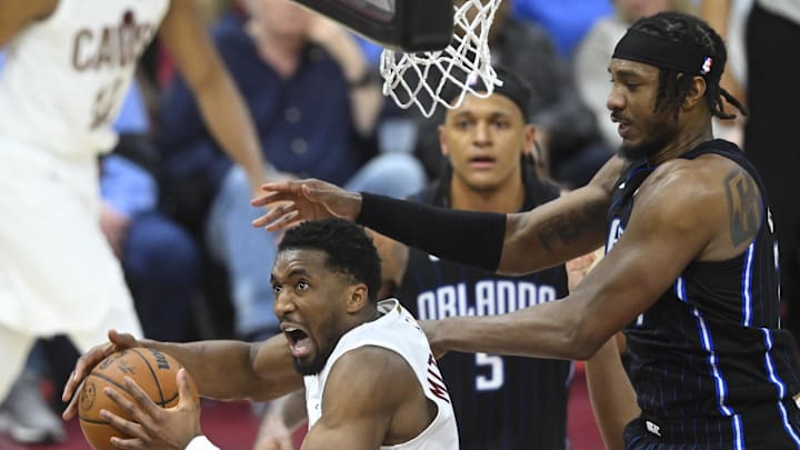 Cavaliers guard Donovan Mitchell drives to the basket beside Magic center Wendell Carter Jr. last season.