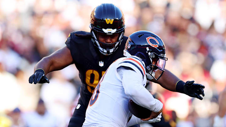 Oct 27, 2024; Landover, Maryland, USA; Chicago Bears quarterback Caleb Williams (18) is sacked by Washington Commanders defensive tackle Jer'Zhan Newton (95) during the first half at Commanders Field. Mandatory Credit: Peter Casey-Imagn Images