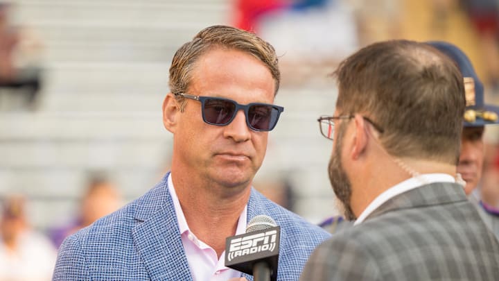 Oct 12, 2024; Baton Rouge, Louisiana, USA;  Mississippi Rebels head coach Lane Kiffin talks to ESPN Radio before a game against the LSU Tigers at Tiger Stadium. Mandatory Credit: Stephen Lew-Imagn Images