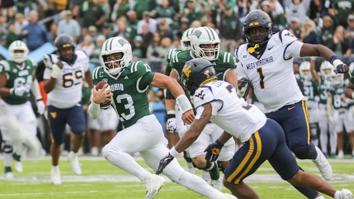 Sep 6, 2025; Athens, Ohio, USA; Ohio Bobcats quarterback Parker Navarro (13) runs the ball during the second quarter against the West Virginia Mountaineers at Peden Stadium. Mandatory Credit: Ben Queen-Imagn Images