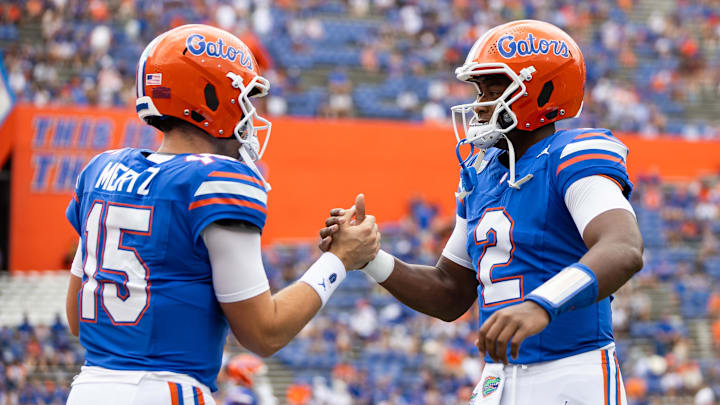 Sep 14, 2024; Gainesville, Florida, USA; Florida Gators quarterback Graham Mertz (15) and Florida Gators quarterback DJ Lagway (2) embrace before a game against the Texas A&M Aggies at Ben Hill Griffin Stadium. Mandatory Credit: Matt Pendleton-Imagn Images