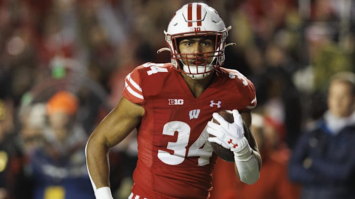 Nov 18, 2023; Madison, Wisconsin, USA;  Wisconsin Badgers running back Jackson Acker (34) rushes for a touchdown during the second quarter against the Nebraska Cornhuskers at Camp Randall Stadium. 