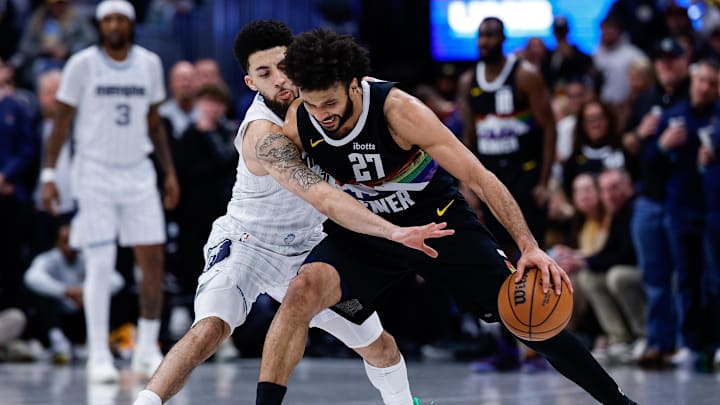 Feb 11, 2026; Denver, Colorado, USA; Denver Nuggets guard Jamal Murray (27) controls the ball under pressure from Memphis Grizzlies guard Scotty Pippen Jr. (1) in the fourth quarter at Ball Arena. Mandatory Credit: Isaiah J. Downing-Imagn Images