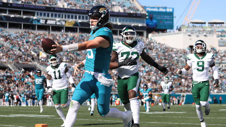 Dec 14, 2025; Jacksonville, Florida, USA; Jacksonville Jaguars quarterback Trevor Lawrence (16) scores a touchdown during the first quarter against the New York Jets at EverBank Stadium. Mandatory Credit: Morgan Tencza-Imagn Images