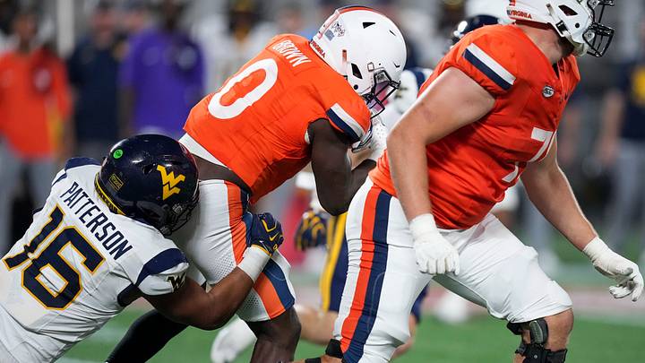 Sep 19, 2026; Charlotte, North Carolina, USA;  West Virginia Mountaineers linebacker Isaiah Patterson (16) tackles Virginia Cavaliers running back Xavier Brown (0) at the line of scrimmage during the second quarter at Bank of America Stadium.  Mandatory Credit: Jim Dedmon-Imagn Images