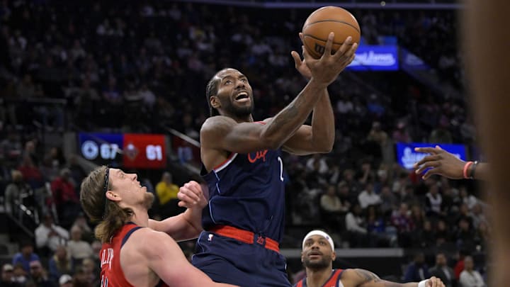 Apr 2, 2025; Inglewood, California, USA;  Los Angeles Clippers forward Kawhi Leonard (2) drives past New Orleans Pelicans forward Kelly Olynyk (13) for a basket in the second half at Intuit Dome. Mandatory Credit: Jayne Kamin-Oncea-Imagn Images