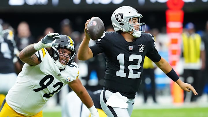 Oct 13, 2024; Paradise, Nevada, USA; Las Vegas Raiders quarterback Aidan O'Connell (12) is flushed from the pocket by Pittsburgh Steelers defensive tackle Isaiahh Loudermilk (92) during the second quarter at Allegiant Stadium. Mandatory Credit: Stephen R. Sylvanie-Imagn Images